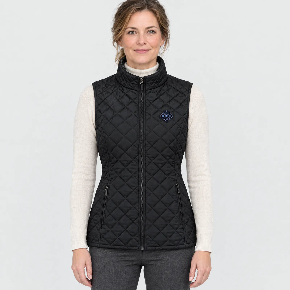 Woman wearing the black heated quilted vest, front view