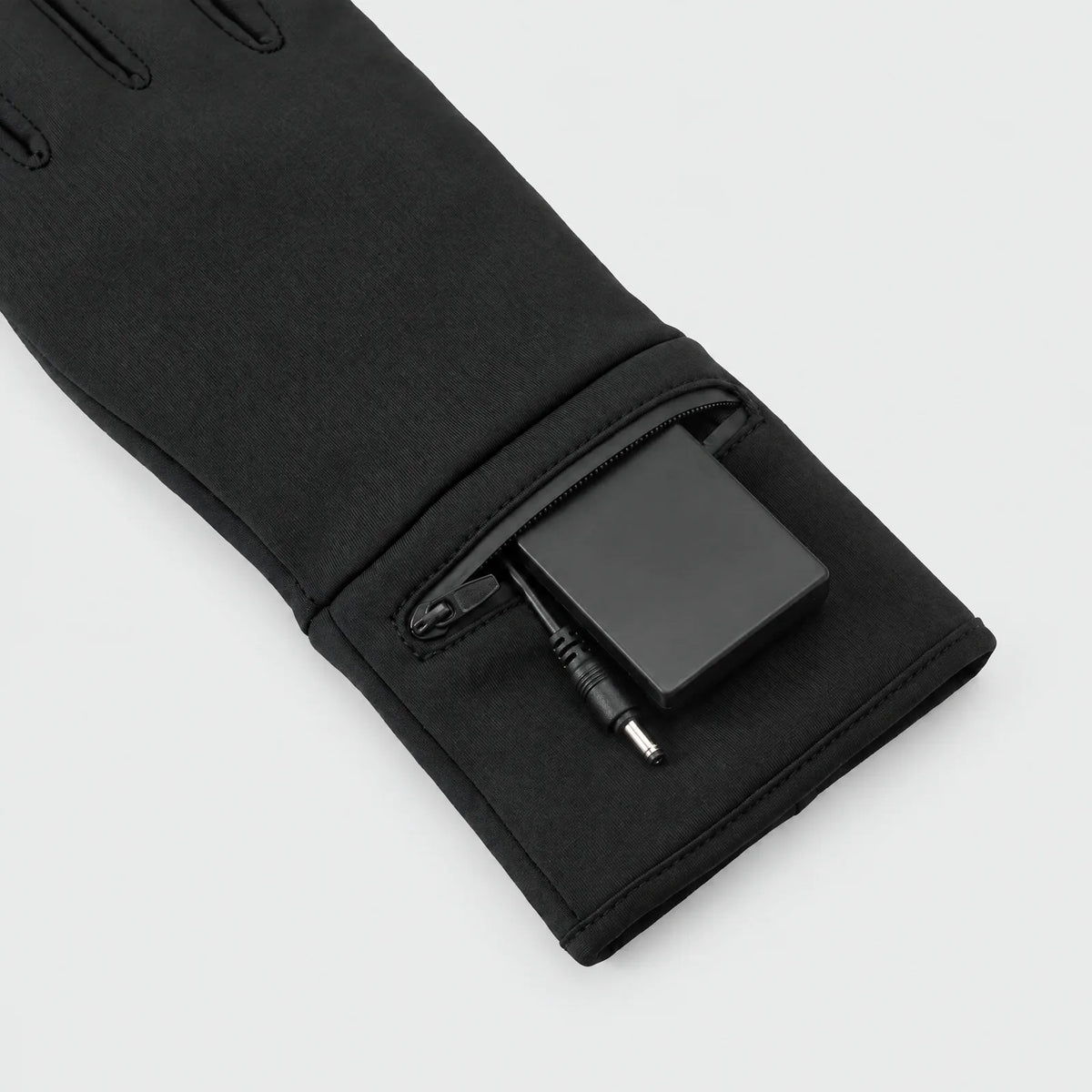 Battery in the zipped pocket on the cuff of the heated liner gloves